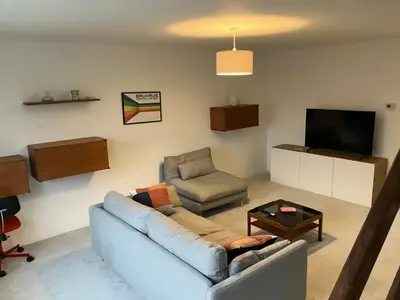 a living room with a couch and a chair and a tv at 4 De Vere Lane, Wivenhoe in Wivenhoe