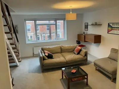 a living room with a couch and a table at 4 De Vere Lane, Wivenhoe in Wivenhoe