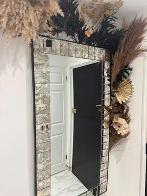 a mirror on a wall with a wreath at Lavish The White Apartment in Bury Saint Edmunds