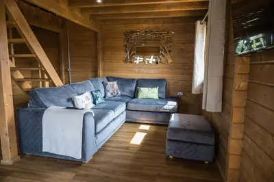 a living room with a blue couch in a cabin at Buzzards Retreat in Larling