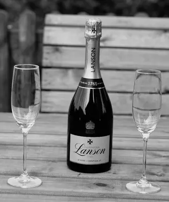 a bottle of wine and two glasses on a table at Buzzards Retreat in Larling
