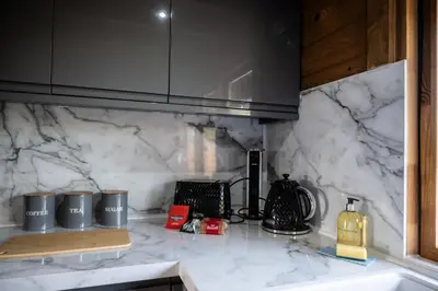 a kitchen with a marble counter top with a counter top at Buzzards Retreat in Larling