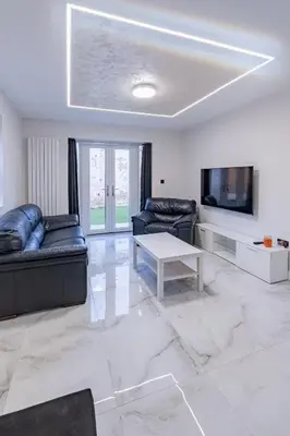 a living room with couches and a tv and a table at Hamlet Hideaway Sleeps 14 Off Street Parking - Pass the Keys in Westcliff On Sea