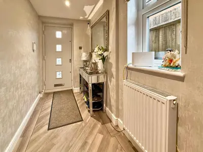 a hallway of a home with a radiator and a window at Charming 3 bedroom house in Chelmsford in Chelmsford