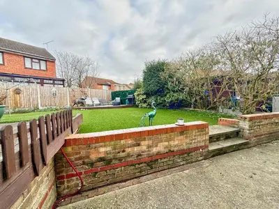 a bird sitting on top of a brick wall at Charming 3 bedroom house in Chelmsford in Chelmsford