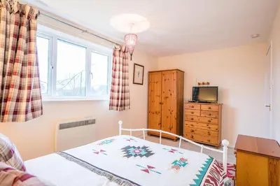 a bedroom with a bed and a window at 1 Hall Farm Cottage, Aldeburgh in Aldeburgh