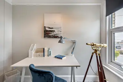 a white desk with a lamp and a blue chair at 3 Bed in Felixstowe oc-s27808 in Felixstowe