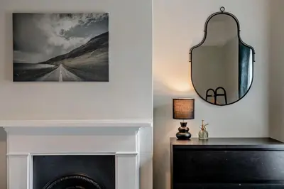 a mirror over a fireplace in a living room at 3 Bed in Felixstowe oc-s27808 in Felixstowe