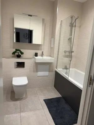 a bathroom with a toilet and a sink and a shower at Luxury Modern Apartment in Central Chelmsford in Chelmsford