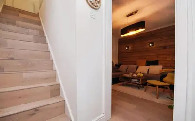 a stairway leading into a living room with a couch at House in Harold Wood in Harold Wood