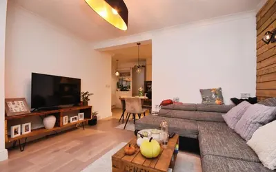 a living room with a couch and a flat screen tv at House in Harold Wood in Harold Wood