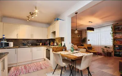 a kitchen with a wooden table and a dining room at House in Harold Wood in Harold Wood
