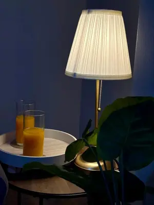 two glasses of orange juice on a table next to a lamp at The Opulent Property Project Southend 4 Bed Sleeps 7 in Southend-on-Sea