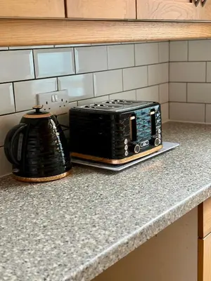 a toaster oven sitting on a counter in a kitchen at The Opulent Property Project Southend 4 Bed Sleeps 7 in Southend-on-Sea