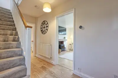 a staircase in a home with a door leading to a hallway at The Opulent Property Project Colchester 3BR nr Station Sleeps 6 Fastwifi Free Parking in Lexden