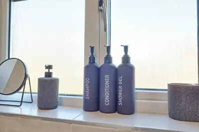 three blue bottles sitting on a window sill at The Opulent Property Project Colchester 3BR nr Station Sleeps 6 Fastwifi Free Parking in Lexden