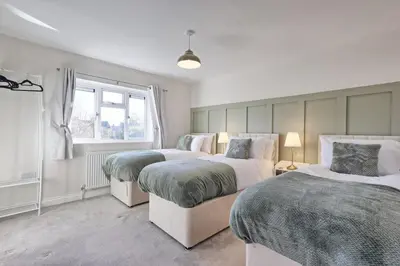 a bedroom with two beds and a window at The Opulent Property Project Colchester 3BR nr Station Sleeps 6 Fastwifi Free Parking in Lexden
