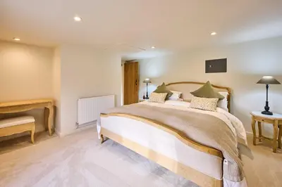 a bedroom with a large bed in a room at Host & Stay The Coral Cottage in Wymondham