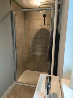 a shower in a bathroom with a sink at Townfield Lodge in Bury Saint Edmunds
