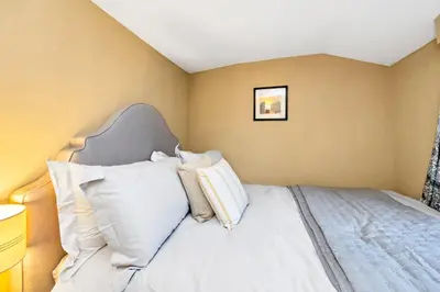 a bedroom with a bed with white pillows at Charming Guildhall street - sleeps up to 6 guests in the Medieval Grid in Bury Saint Edmunds
