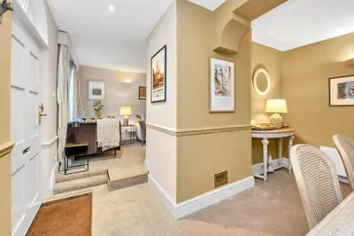 a living room with a hallway with a table and chairs at Charming Guildhall street - sleeps up to 6 guests in the Medieval Grid in Bury Saint Edmunds