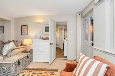 a living room with a couch and a table at Charming Guildhall street - sleeps up to 6 guests in the Medieval Grid in Bury Saint Edmunds