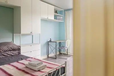 a small bedroom with a bed and a desk at Steps from Train Station - Modern 2-Bedroom with Balcony & Cambridge Amenities, Family Friendly in Cambridge
