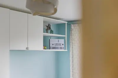 a bathroom with a shelf with a sign that says i live somewhere at Steps from Train Station - Modern 2-Bedroom with Balcony & Cambridge Amenities, Family Friendly in Cambridge