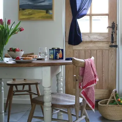 a kitchen with a table and a chair with a table at The Old Post Box in Holton