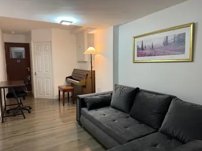 a living room with a couch and a piano at Stevenage Contractor & Family Retreat in Stevenage
