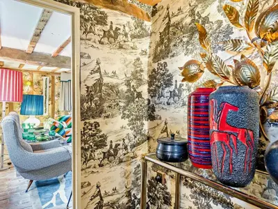 a living room with a wall covered in a tapestry at 4 Bed in Eye- oc-34389 in Thornham Magna