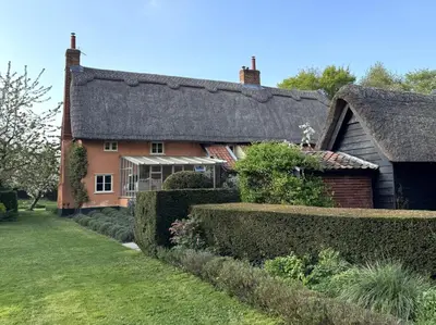 a house with a thatched roof and a yard at 4 Bed in Eye- oc-34389 in Thornham Magna