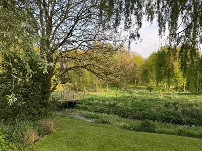 a bridge over a river in a field at 1 Bed in Eye- oc-34390 in Thornham Magna