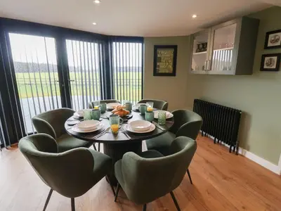 a dining room with a table and chairs at The Corn Silo in Ipswich