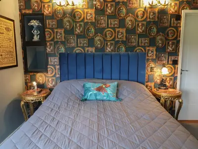 a bedroom with a blue bed with a pillow on it at The Barley Silo in Ipswich