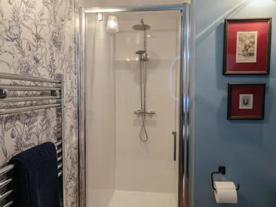 a shower with a glass door in a bathroom at The Barley Silo in Ipswich