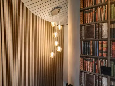 a room with a book shelf with books at The Barley Silo in Ipswich