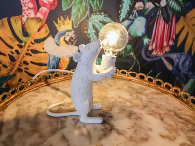 a toy mouse holding a light bulb on a table at The Barley Silo in Ipswich