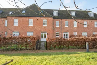 a large red brick building with white windows at Ploughman’s Green, Blythburgh in Halesworth
