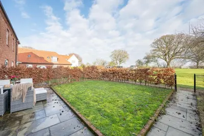 a garden with a lawn and a fence at Ploughman’s Green, Blythburgh in Halesworth