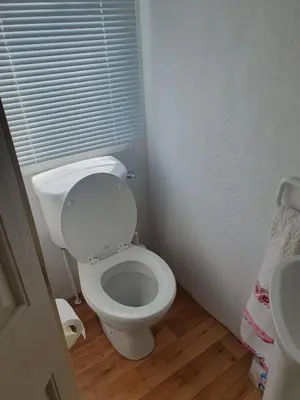 a bathroom with a white toilet and a sink at Hutleys Caravan Holiday Home - St Osyth - Clacton-on-Sea in Saint Osyth