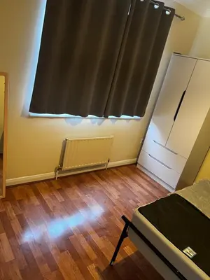 an empty room with a bed and a window at Single Room in town house in Rochford