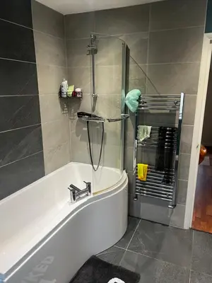 a bathroom with a bath tub and a shower at Single Room in town house in Rochford