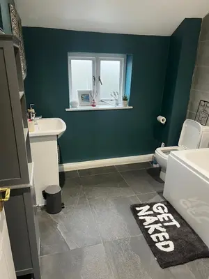 a bathroom with a toilet and a sink and a window at Single Room in town house in Rochford