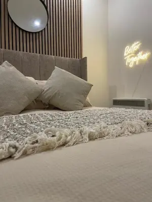 a bed with pillows and a blanket on it at Ipswich Hospital Accommodation, Parking & Wifi in Ipswich