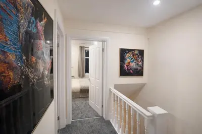 a hallway with a large painting on the wall at Ipswich Hospital Accommodation, Parking & Wifi in Ipswich