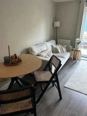 a living room with a table and a couch at 1 bed flat close to Chelmsford City Centre in Chelmsford