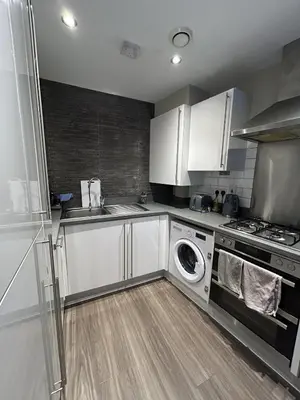 a kitchen with a sink and a washing machine at 1 bed flat close to Chelmsford City Centre in Chelmsford
