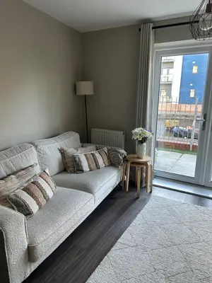 a living room with a couch and a window at 1 bed flat close to Chelmsford City Centre in Chelmsford