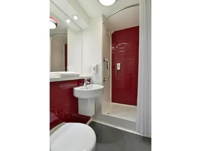 a bathroom with a toilet and a sink and a shower at Travelodge Ipswich in Ipswich